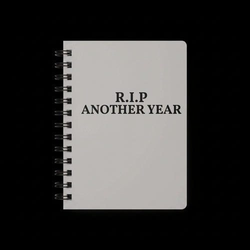 Gray notebook with 'R.I.P. ANOTHER YEAR' text on a white background