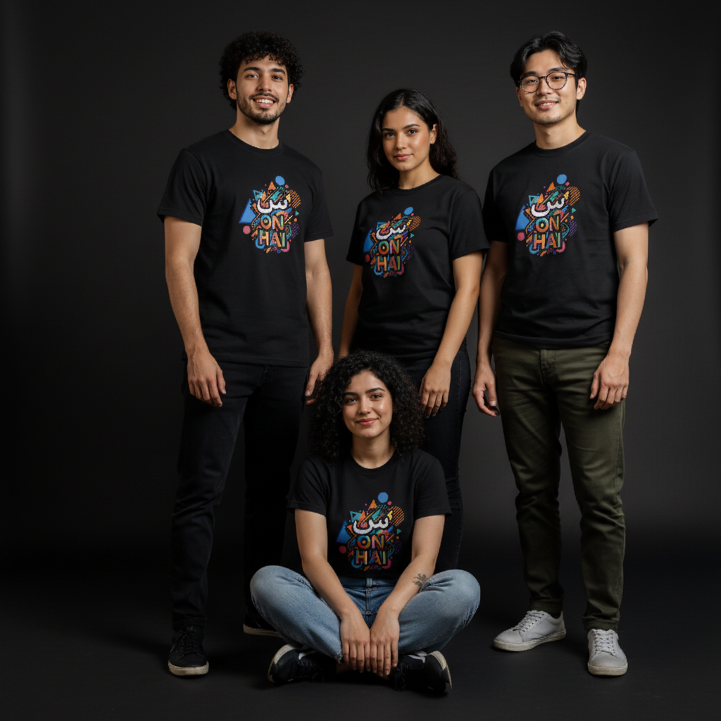 Five people wearing black blooomit novelty t-shirts with colorful graphics and text, sitting indoors.